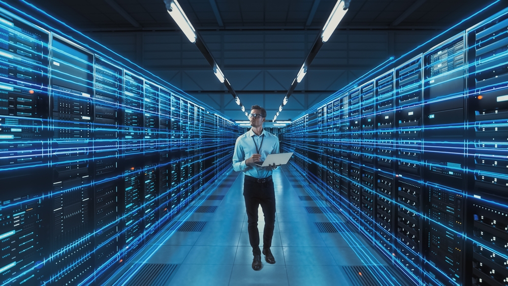 IT technician managing high-speed data flow in a modern server facility