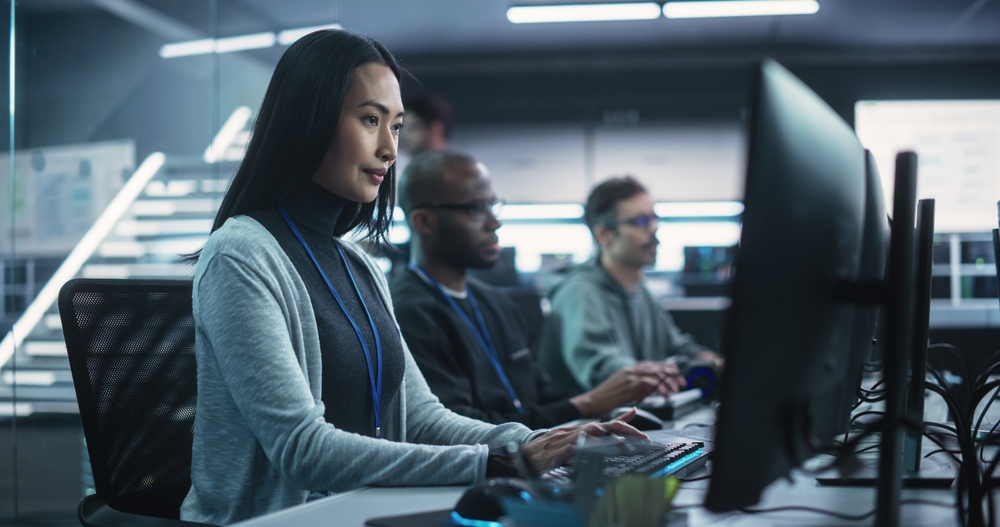 Cybersecurity professionals monitoring systems in a high-tech operations centre