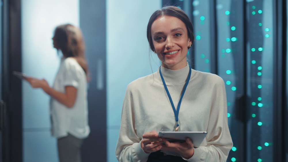 Joyful,Pretty,Young,Woman,It,Technician,Holding,Tablet,Staying,At